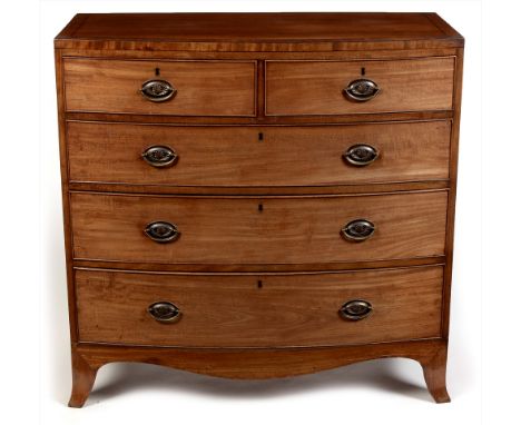 A Regency mahogany and ebony strung bowfront chest of drawers, the shaped caddy top above an arrangement of two short over th
