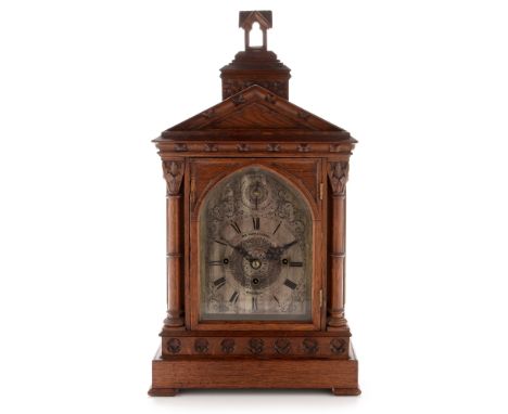 A late 19th Century quarter striking oak bracket clock, the silvered roman dial with scrollwork decoration, subsidiary dial t