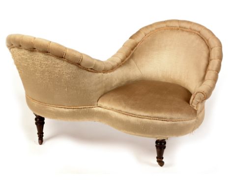 A Victorian conversation seat , upholstered in pale velvet fabric, raised on turned mahogany legs with brass caps and ceramic