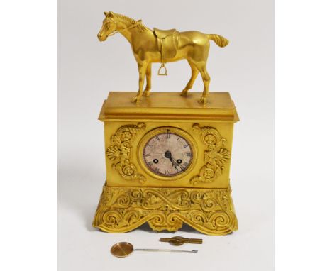 A 19th Century ormolu cased mantel clock, the square case with applied scrolling foliate motifs, circular silvered roman dial