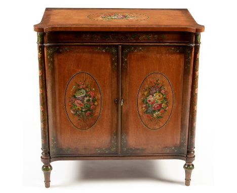 A 20th Century Sheraton revival painted mahogany cabinet , the shaped top with projecting corners and oval cartouche, painted