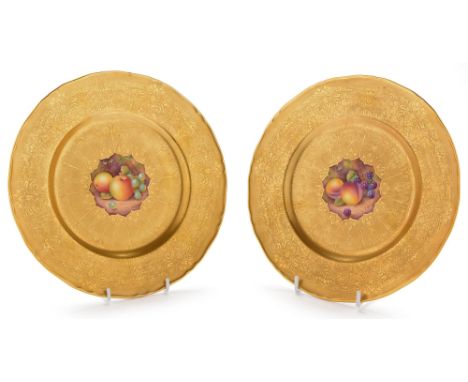 A pair of Worcester fruit painted plates by D. Shinnie , painted with peaches, blackberries, apples and grapes, on a rich too