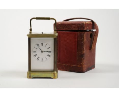 A French brass repeating carriage clock with five panel glass case, platform lever escapement white enamel dial and Roman num