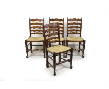 A set of four Titchmarsh & Goodwin beech framed ladder back rush seat chairs on turned legs joined by a turned front stretche