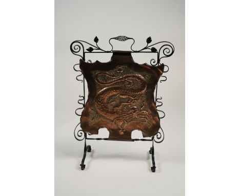 A wrought iron and copper Art Nouveau fire screen embossed with scaly dragon 60cm x 79cm high