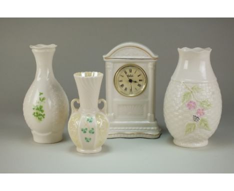 A collection of fifteen pieces of Belleek including shamrock vases, cottage form butter dish and cover, a model of a dog, ass
