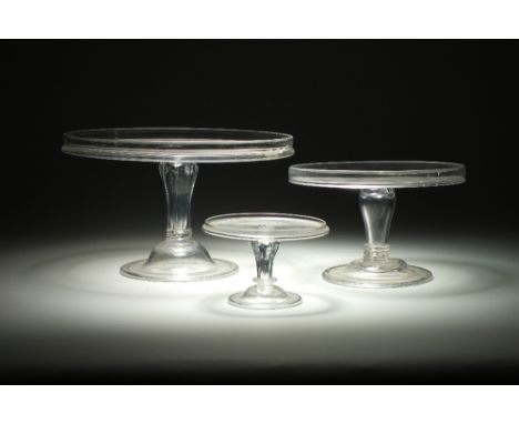 Three late 19th/early 20th century glass pedestal comport cake stands, two single tiered and one twin tiered, the tallest 21c