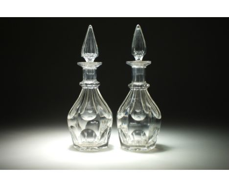 A pair of 19th century glass decanter and stopper, of heavy, multi-faceted form and ribbed upper collar, with a spire-form to