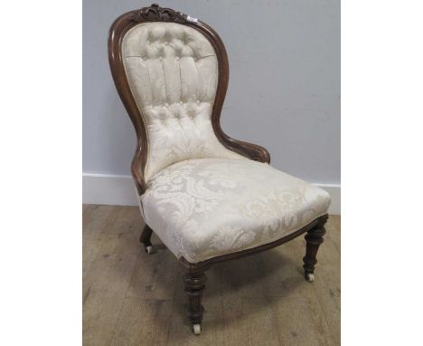 A Victorian walnut frame button back nursing chair on turned legs