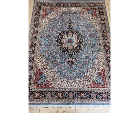 A hand-knotted Kirman carpet, with cebtral medallion on a pale blue ground, 372 x 277cmsuperb condition with no stains or dam