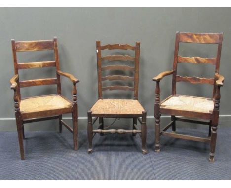 A 19th century rush seated ladder back chair together with two similar ladder back armchairs (3)