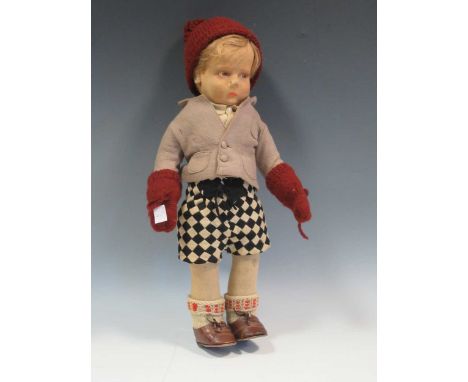 An early 20th century Lenci pressed felt doll of a boy: moulded head with painted eyes, nose and mouth , 44cm high
