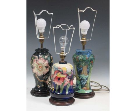 A Moorcroft Orchid pattern table lamp and two others tallest 37cm high (without fitting)