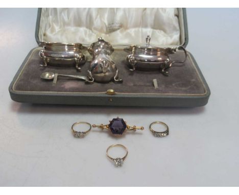 a hallmarked 9ct gold three stone diamond ring, a white stone ring tested as 9ct gold, an amethyst brooch stamped '9CT', gros