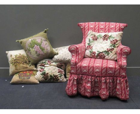 A button-backed nursing armchair, on square mahogany legs; and various floral patterned cushions