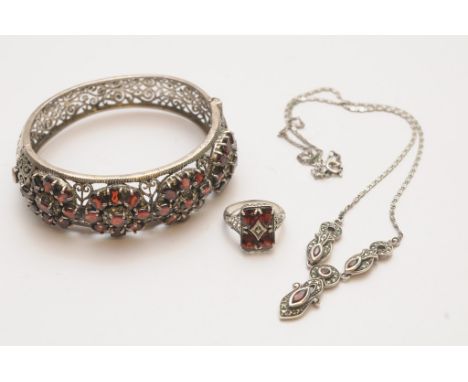 A Victorian style pierced silver and garnet set bangle and ring with matched necklace