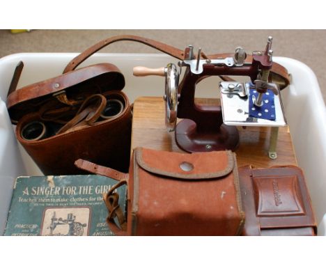 A collection of items comprising a boxed Singer For the Girls miniature working sewing machine, one other miniature sewing ma