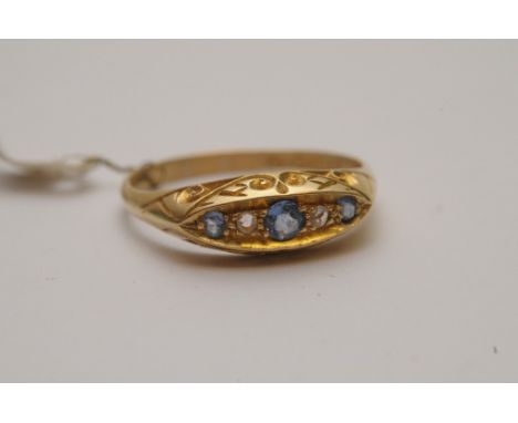A ladies 18ct gold boat shaped ring bearing Chester hallmarks and set with sapphires and diamonds