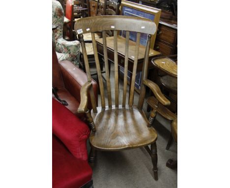 A stick back open armchair having elm seat