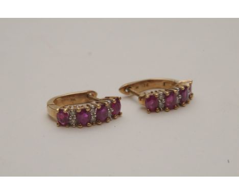 A pair of ladies 9ct gold diamond and ruby set half hoop earrings