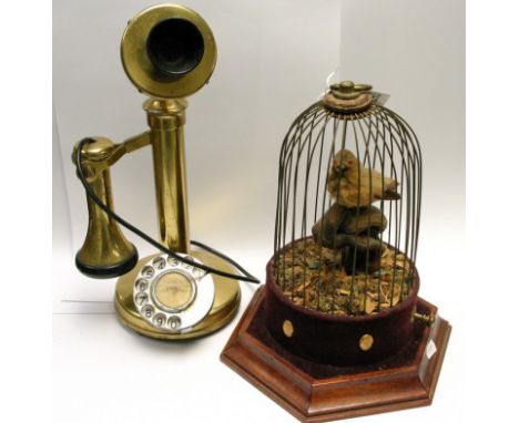 A singing bird in a cage and a reproduction stick telephone
