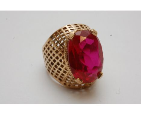 A 10ct gold ring inset with a ruby coloured stone 