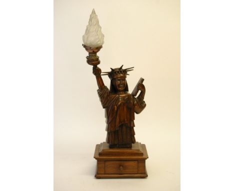 A carved table-lamp in the form of the Statue of Liberty