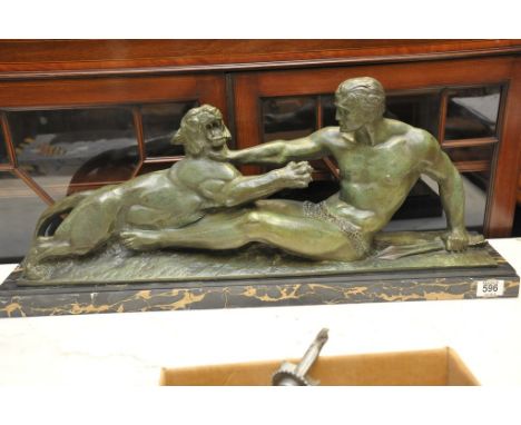 An Art Deco bronze depicting Hercules and the Nemean lion on marble base. Signed Jean Magrou. Measuring 77cm in length. 