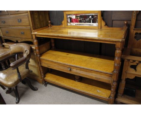 An oak buffet with open shelves and turned pillar supports