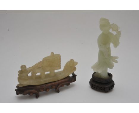 Two Chinese jade carvings on wooden bases, one in the form of a robed lady, the other two figures on a boat 