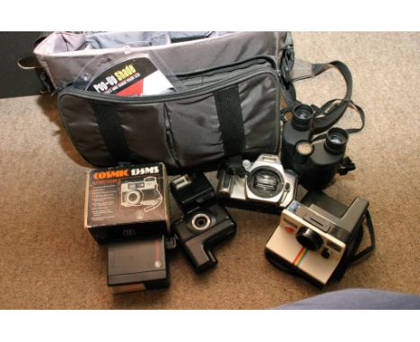 A camera bag containing various photographic equipment including Polaroid camera, Minolta camera body etc 