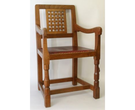 A carved oak Robert Thompson, The Mouseman, open armchair with lattice back