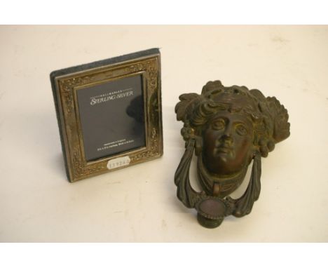 An Art Nouveau type cast metal door knocker and a silver plated photo frame