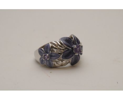 A ladies silver ring of flower design set with amethyst and purple enamel