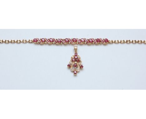 A 14ct gold ruby and diamond set bracelet with matching pendant