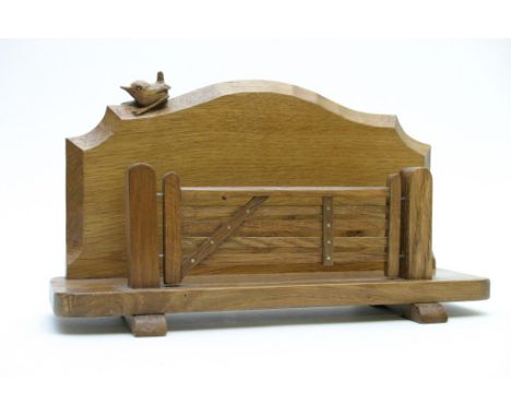 A carved oak Bob Hunter Wren Man letter rack with five bar gate design