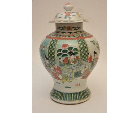 A large quality Chinese famille verte lidded temple jar of baluster form decorated with figures in a garden setting, the base
