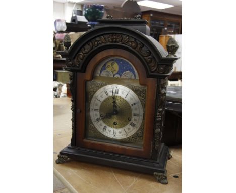 A 20th century bracket clock with moon face and fitted with a three train movement 