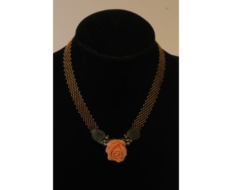 An 18ct gold diamond, coral and jade necklace, the coral in the form of a flower, flanked with good coloured diamonds and jad