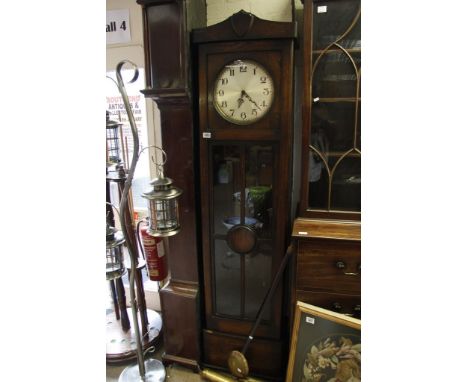 A 1920's Oak Longcase Clock the circular dial with Arabic numerals with visible weights and pendulum