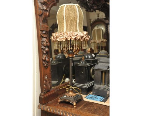 A contemporary standard lamp with matching side lamps