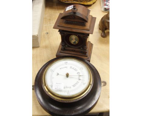 A circular wall barometer and a continental clock case 