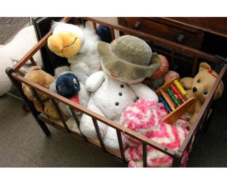 A collection of assorted vintage soft toys and child's cot including a Merrythought sit on top toy pig