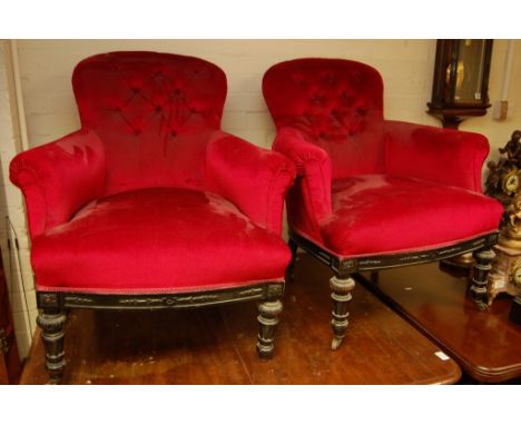 A pair of 19th century button back arm chairs with red draylon upholstery and  carved ebonised rails and feet