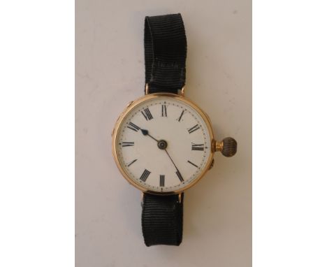 A 14ct yellow gold button wind wristwatch with black fabric strap