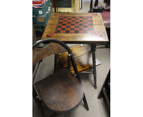 A games table with chessboard top together with a separate backgammon board and a set of four folding chairs