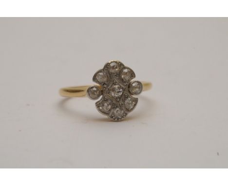A ladies 18ct yellow gold ring of Art Deco design set with nine Old European cut diamonds
