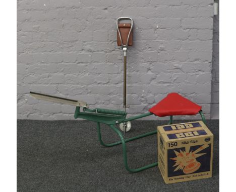 A manual seated single arm clay pigeon trap mounted on painted tubular steel frame, along with a box of 150 midi size clays a