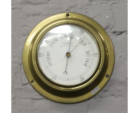 A wall mounted brass barometer by Dobbie McInnes Limited.