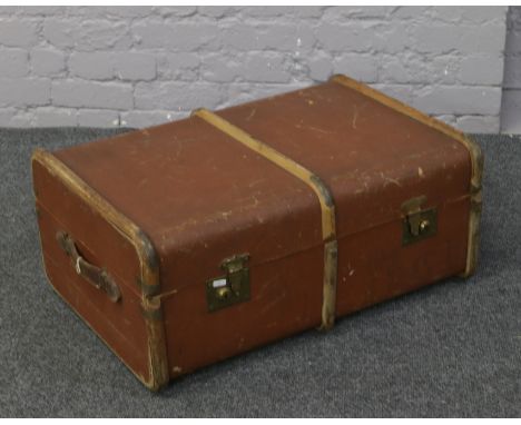 A vintage wood bound travel trunk.